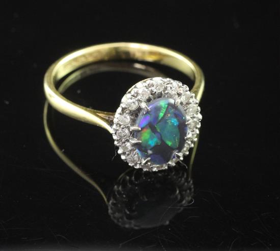 An 18ct gold, platinum, black opal and diamond cluster ring, size O.